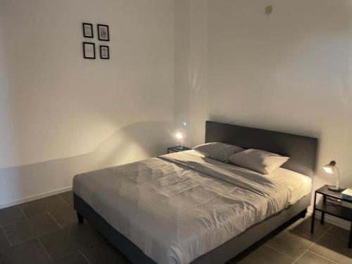 a bedroom with a large bed and two tables at Station 171 Bruxelles-charleroi-airport in Charleroi