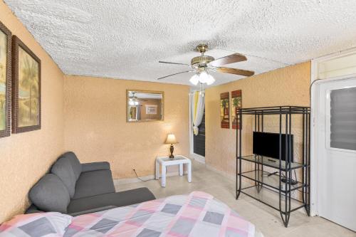 a bedroom with a couch and a tv in a room at Not only you have a view condo in Christiansted