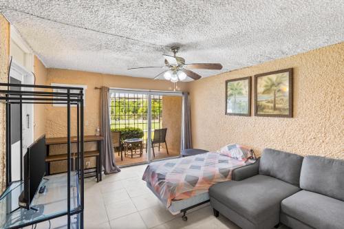 a living room with a couch and a ceiling fan at Not only you have a view condo in Christiansted