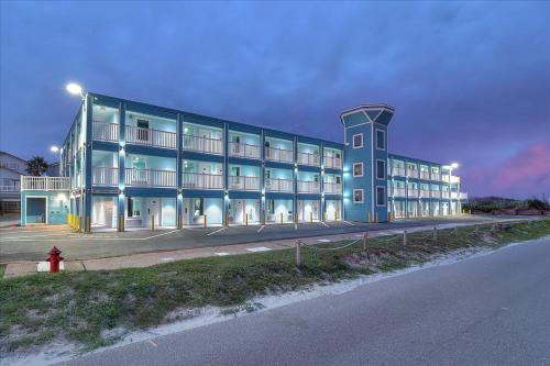 a large blue building with a fire hydrant in front of it at Seaside Boutique Hotel, Waves At Your Doorstep in Port Aransas