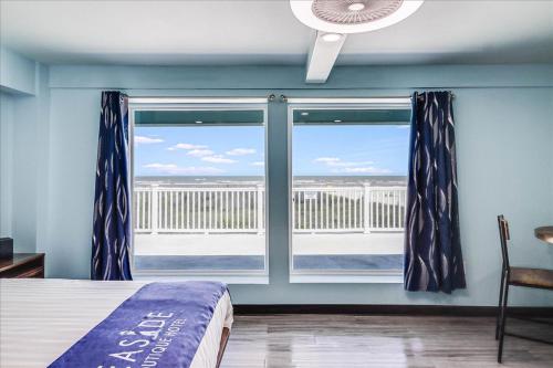 a bedroom with a window with a view of the ocean at Seaside Boutique Hotel, Waves At Your Doorstep in Port Aransas