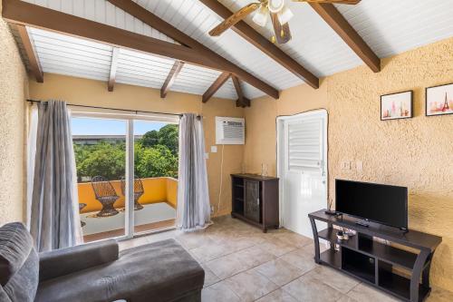 a living room with a couch and a television at Caribbean View Style condo in Christiansted