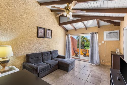 a living room with a couch and a ceiling fan at Caribbean View Style condo in Christiansted