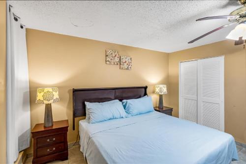 a bedroom with a bed and a ceiling fan at Caribbean home with a view condo in Christiansted