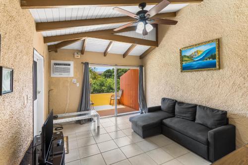 a living room with a couch and a ceiling fan at Caribbean View for You condo in Christiansted