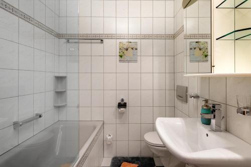 a bathroom with a tub and a toilet and a sink at Landhaus Josefa in Flachau