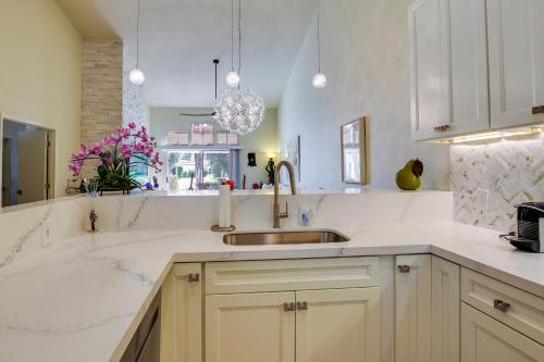 a kitchen with white counter tops and a sink at Tennis, Golf and Pools Lovely Palm Desert Condo! in Palm Desert