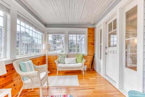 a room with two chairs and a door with windows at Oceans Away in Seaside
