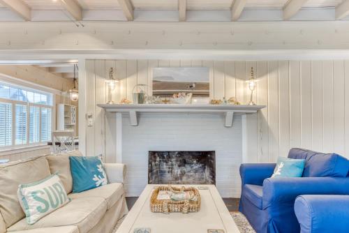 a living room with a couch and a fireplace at Oceans Away in Seaside