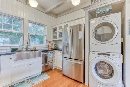 a kitchen with a refrigerator and a washer and dryer at Oceans Away in Seaside
