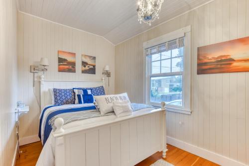 a white bedroom with a bed and a window at Oceans Away in Seaside