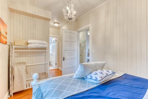 a bedroom with a blue bed and a chandelier at Oceans Away in Seaside