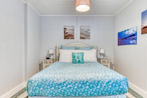 a bedroom with a bed and two night stands at Oceans Away in Seaside