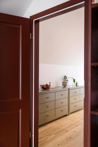 an open door leading into a bedroom with a dresser at Resort po.spolu in Mokrovraty