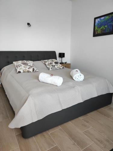 a bed with two towels on it in a bedroom at Aquarius Stawy Walczewskiego 7 in Grodzisk Mazowiecki