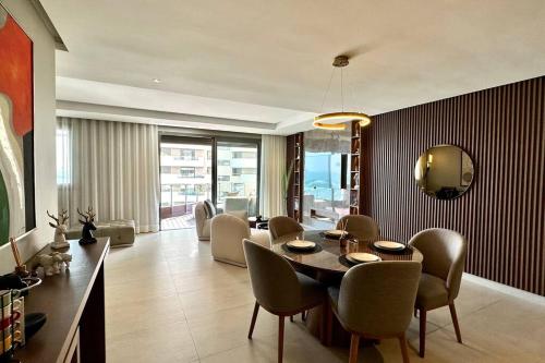 a living room with a dining table and chairs at Marina State of Peace - Sea View in Casablanca