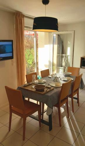 une table à manger avec des chaises, une table et une télévision dans l'établissement 