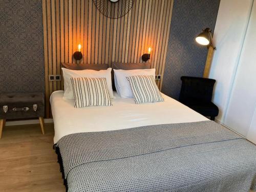 a bedroom with a large white bed with two pillows at Appart'Hotel - Gare TGV - Courtine - Confluence - 407 bis in Avignon