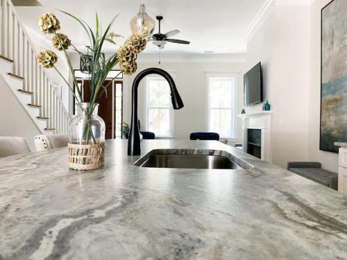 a kitchen with a sink and a vase with flowers at Magnolia Estate - 3 Separate Units, Courtyard in Savannah