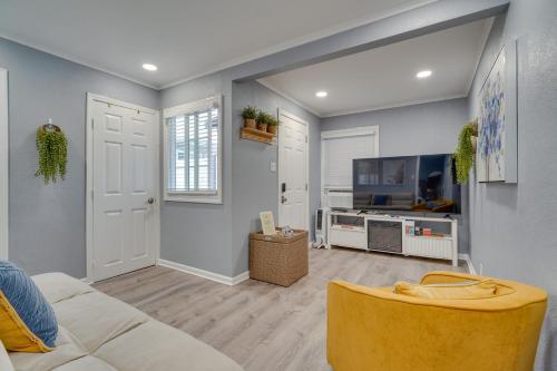 a living room with a couch and a tv at Cozy Bay Area Vacation Rental with Patio in Hayward