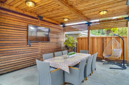 a patio with a table and chairs and a television at Cozy Bay Area Vacation Rental with Patio in Hayward