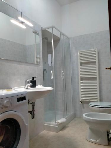 a bathroom with a shower and a sink and a washing machine at james house green in Teramo