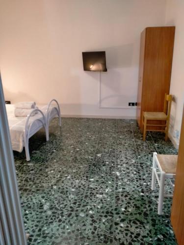 Cette chambre comprend un lit et une télévision murale. dans l'établissement james house green, à Teramo