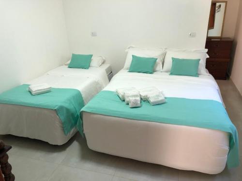 Katil atau katil-katil dalam bilik di Gardenian Boutique Hotel