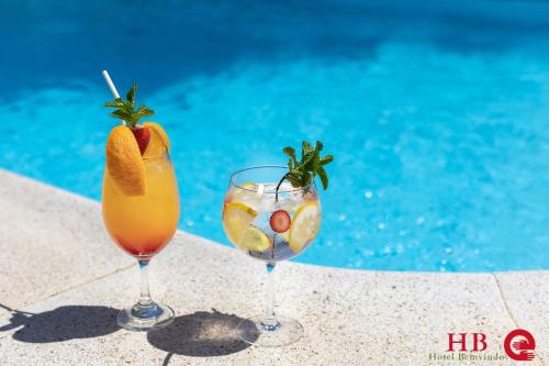 two cocktails in glasses next to a swimming pool at Urban Hotel Santa Eulalia in Albufeira