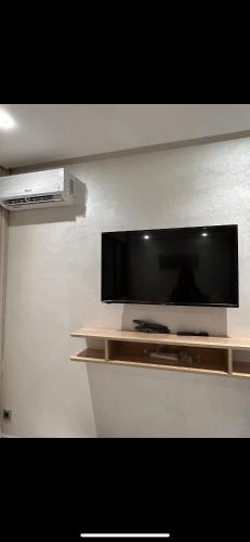 a flat screen tv on a wall at Maarif Elite Suites in Casablanca