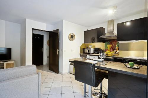 a kitchen with a counter top in a room at Chic apart duplex with parking in Palaiseau