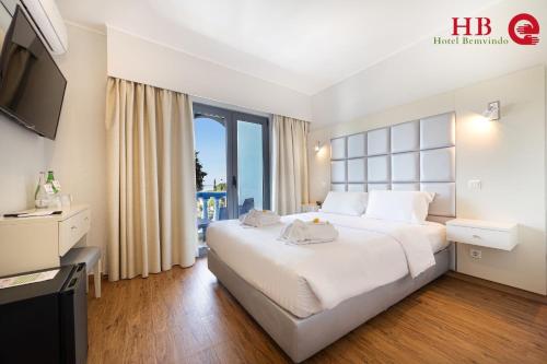 a hotel room with a large bed and a television at Urban Hotel Santa Eulalia in Albufeira