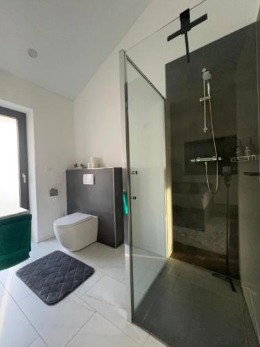 a bathroom with a shower with a cross on the wall at Penthouse in Bad Berleburg in Bad Berleburg