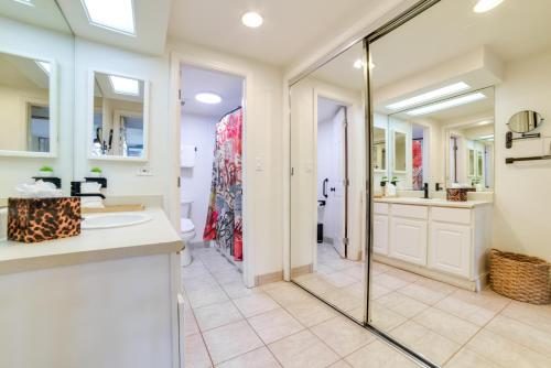 a bathroom with a shower and a sink and a mirror at Island Oasis Near Kaanapali Beach and Black Rock in Lahaina