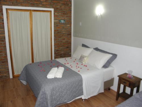 a bedroom with a bed with red flowers on it at Pousada Costa e Mar in Tavares