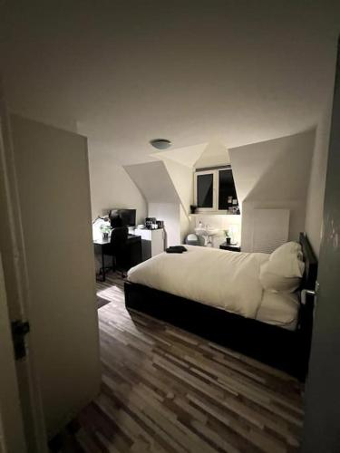 a bedroom with a bed and a desk in it at Cozy Private Room 4 on a Busy Persian Restaurant in Eindhoven