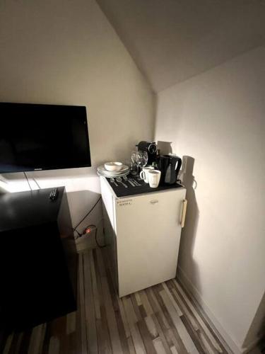 a small kitchen with a stove and a tv at Cozy Private Room 4 on a Busy Persian Restaurant in Eindhoven