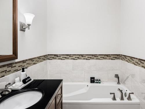 a bathroom with a bath tub and a sink at Flag House Inn in Annapolis