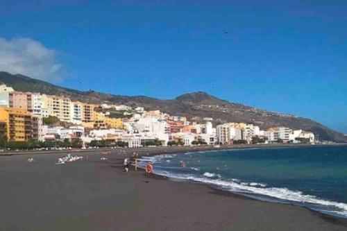 a view of a beach with buildings and the ocean at ÉPOCA in Santa Cruz de la Palma