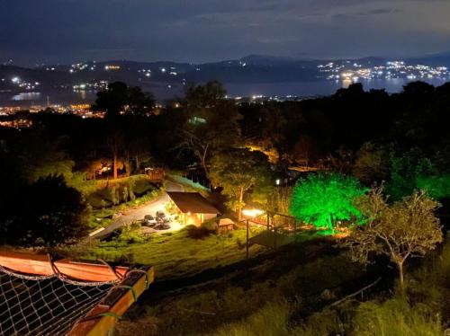 a view of a park at night with green lights at MACA GLAMPING in Calima