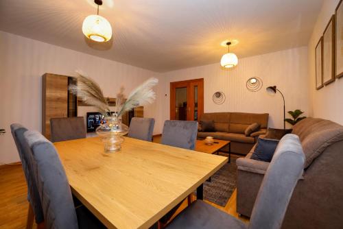 a dining room with a wooden table and chairs at ÁGORA in El Burgo de Osma