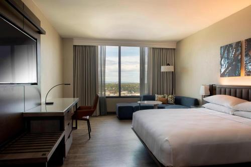 a hotel room with a bed and a large window at Winston-Salem Marriott in Winston-Salem