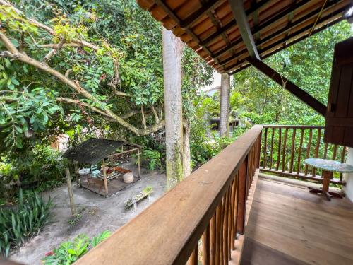 une terrasse en bois avec vue sur le jardin dans l'établissement Barra Quintal Apto 04, à Barra Grande
