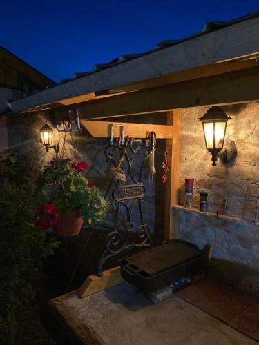 a patio with a grill and lights on a wall at Nantucket GuestHouse in Vrbas