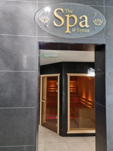a building with a sign that reads the spa hyneys at Lucy's Lodge in Rhyl