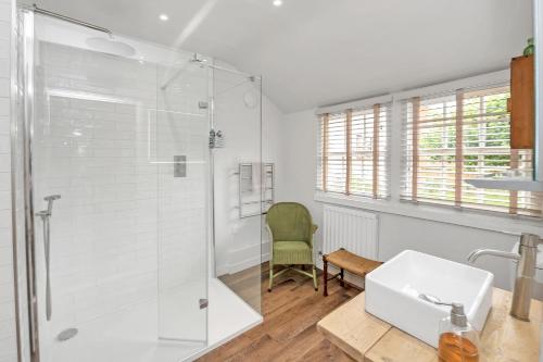 a bathroom with a shower and a sink at The Red Shed Entire home for 2 Private garden and parking 2 miles from Bury St Edmunds in Whepstead