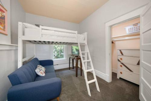 a living room with a blue couch and a bunk bed at 2BR 1BA Small Town Feel Pets Allowed in Spokane