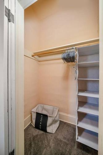 a walk in closet with a shelf and a bag at 2BR 1BA Small Town Feel Pets Allowed in Spokane