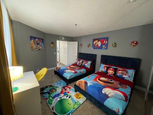 a bedroom with two beds and a bed and a desk at Hollywood Apartment One Bedroom with Mario in Los Angeles