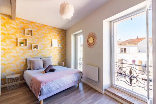 1 dormitorio con cama y ventana grande en AU PIED Du Grand Bassin, en Castelnaudary